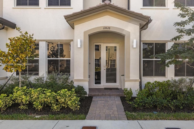 12828 SW 243rd St Unit 12828, Homestead, FL 33032 - doorway to property featuring stucco siding and french doors