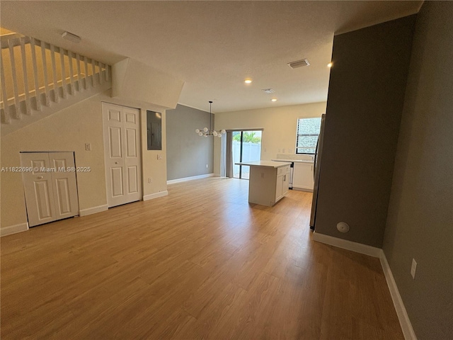 10586 W 33rd Ct Unit 10586, Hialeah, FL 33018 - unfurnished living room with a chandelier, light wood finished floors, and recessed lighting