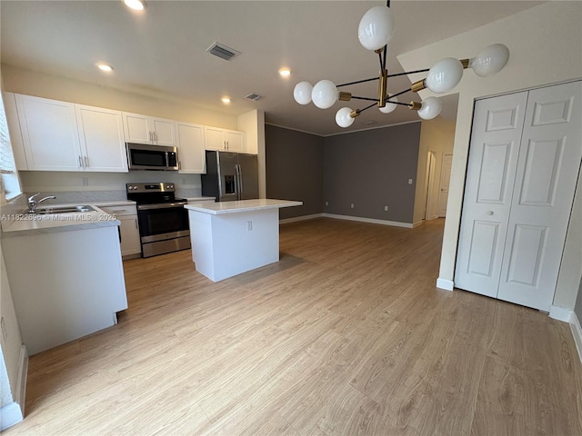 10586 W 33rd Ct Unit 10586, Hialeah, FL 33018 - kitchen featuring stainless steel appliances, light countertops, a chandelier, white cabinetry, and a kitchen island