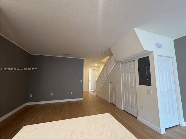 10586 W 33rd Ct Unit 10586, Hialeah, FL 33018 - empty room with electric panel, wood finished floors, and stairs
