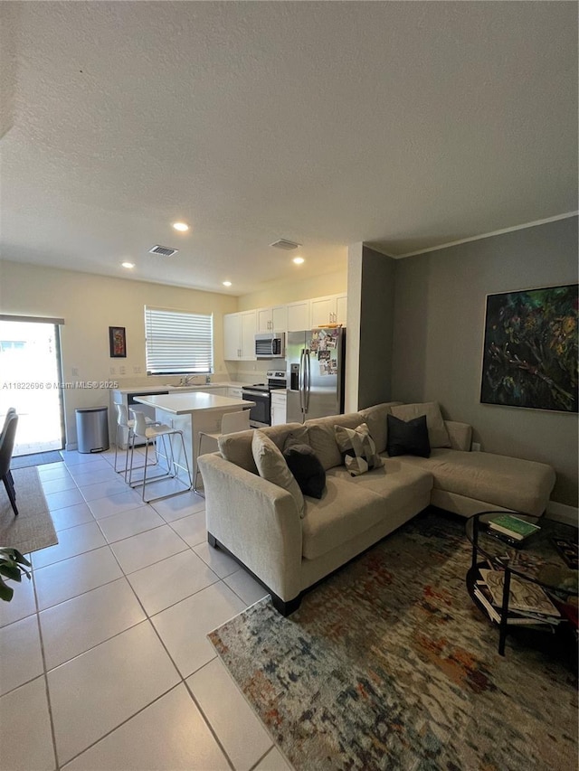 10586 W 33rd Ct Unit 10586, Hialeah, FL 33018 - living room with a textured ceiling, light tile patterned floors, and recessed lighting