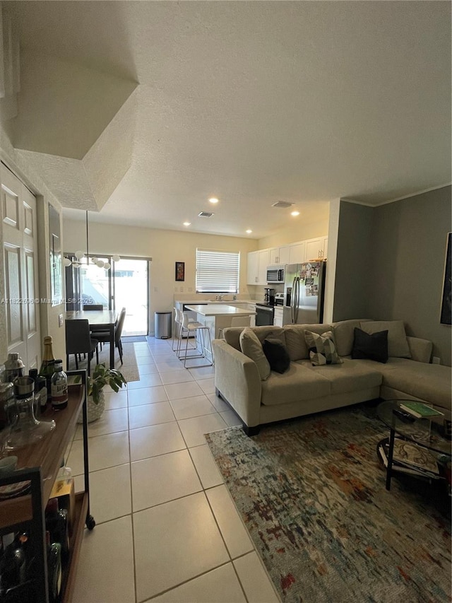 10586 W 33rd Ct Unit 10586, Hialeah, FL 33018 - living room featuring light tile patterned floors, recessed lighting, and a textured ceiling