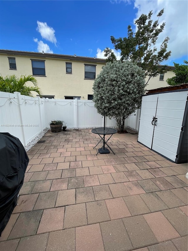 10586 W 33rd Ct Unit 10586, Hialeah, FL 33018 - fenced backyard with a patio and a storage shed
