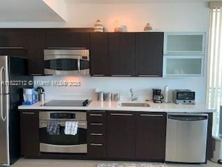 90 SW 3rd St Unit 3010, Miami, FL 33130 - kitchen with stainless steel appliances, light countertops, and modern cabinets
