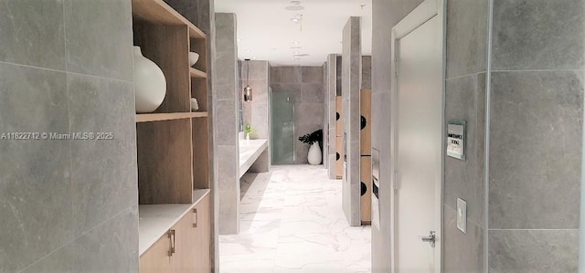 90 SW 3rd St Unit 3010, Miami, FL 33130 - bathroom featuring marble finish floors, a bathtub, vanity, and tile walls