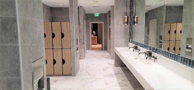 90 SW 3rd St Unit 3010, Miami, FL 33130 - bathroom featuring tile walls, marble finish flooring, and double vanity