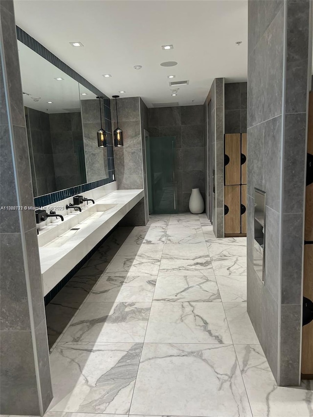 90 SW 3rd St Unit 3010, Miami, FL 33130 - full bathroom with tile walls, vanity, marble finish flooring, and recessed lighting