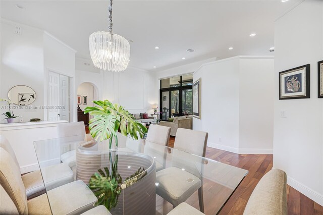 2489 Eagle Watch Ln, Weston, FL 33327 - dining space featuring arched walkways, wood finished floors, a chandelier, and recessed lighting
