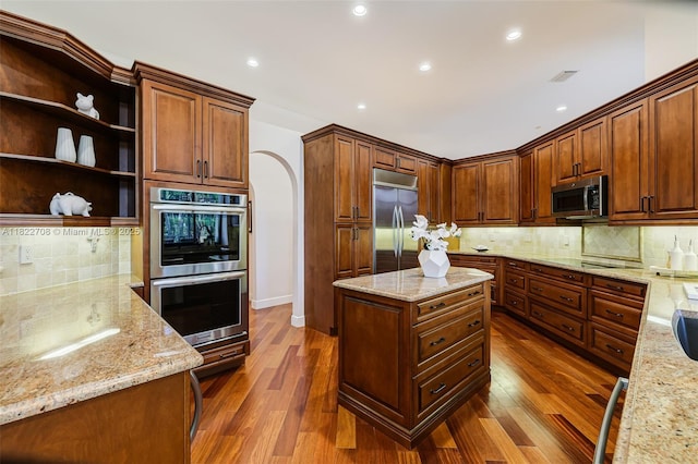 2489 Eagle Watch Ln, Weston, FL 33327 - kitchen with stainless steel appliances, tasteful backsplash, dark wood finished floors, light stone counters, and recessed lighting