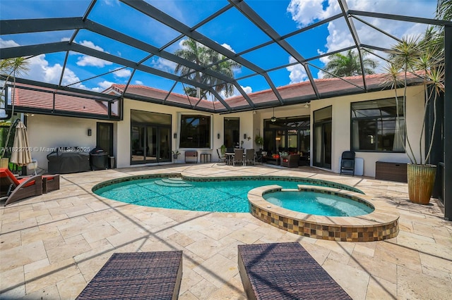 2489 Eagle Watch Ln, Weston, FL 33327 - view of swimming pool featuring a patio, a ceiling fan, a pool with connected hot tub, and glass enclosure