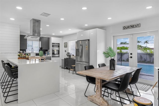 10371 SW 44th St, Miami, FL 33165 - kitchen with stainless steel appliances, island exhaust hood, a peninsula, modern cabinets, and a breakfast bar area