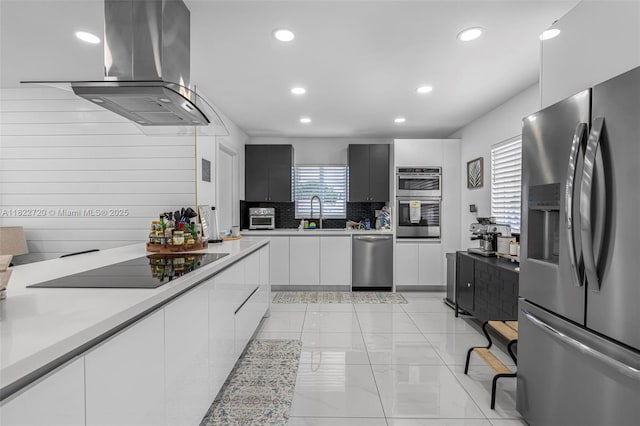 10371 SW 44th St, Miami, FL 33165 - kitchen with stainless steel appliances, wall chimney exhaust hood, light countertops, light marble finish flooring, and recessed lighting