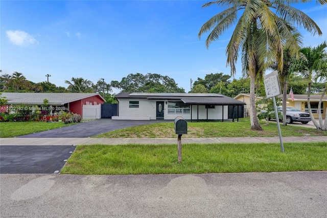1772 SW 43rd Ave, Fort Lauderdale, FL 33317 - ranch-style house featuring roof mounted solar panels and driveway