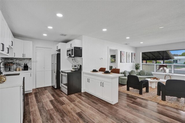 1772 SW 43rd Ave, Fort Lauderdale, FL 33317 - kitchen with appliances with stainless steel finishes, open floor plan, a peninsula, recessed lighting, and dark wood-type flooring