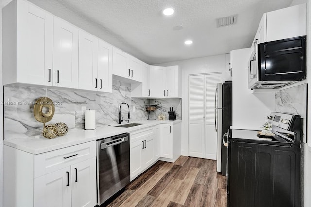 1772 SW 43rd Ave, Fort Lauderdale, FL 33317 - kitchen with appliances with stainless steel finishes, light countertops, wood finished floors, backsplash, and recessed lighting
