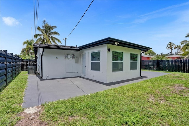 1772 SW 43rd Ave, Fort Lauderdale, FL 33317 - back of house with stucco siding, a patio area, and a fenced backyard