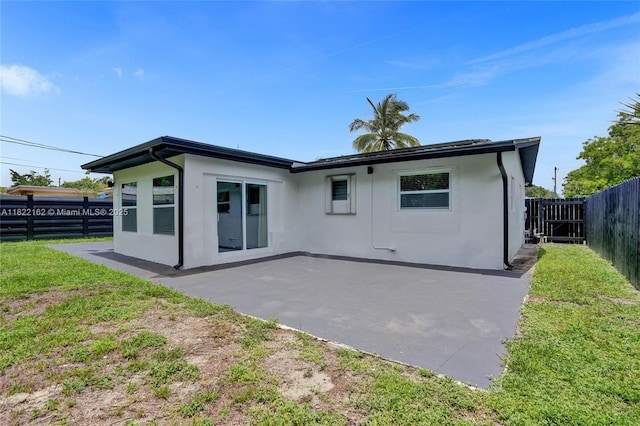 1772 SW 43rd Ave, Fort Lauderdale, FL 33317 - back of house featuring stucco siding, a patio area, and a fenced backyard