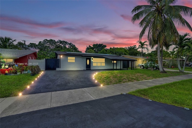 1772 SW 43rd Ave, Fort Lauderdale, FL 33317 - mid-century modern home featuring roof mounted solar panels, concrete driveway, and a gate