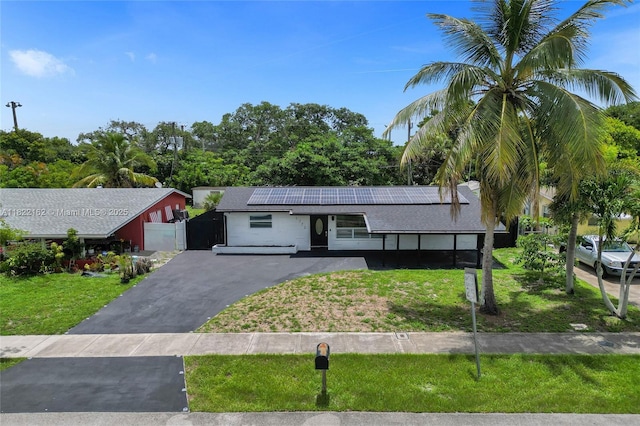 1772 SW 43rd Ave, Fort Lauderdale, FL 33317 - single story home with roof mounted solar panels and driveway