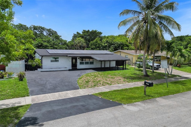 1772 SW 43rd Ave, Fort Lauderdale, FL 33317 - ranch-style home featuring asphalt driveway, a front yard, and solar panels