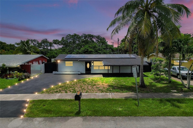 1772 SW 43rd Ave, Fort Lauderdale, FL 33317 - ranch-style home featuring roof mounted solar panels, a gate, and asphalt driveway