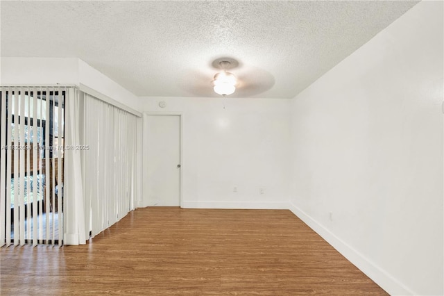 1150 N Liberty Ave Unit 1150G, Homestead, FL 33034 - unfurnished room featuring wood finished floors and a textured ceiling