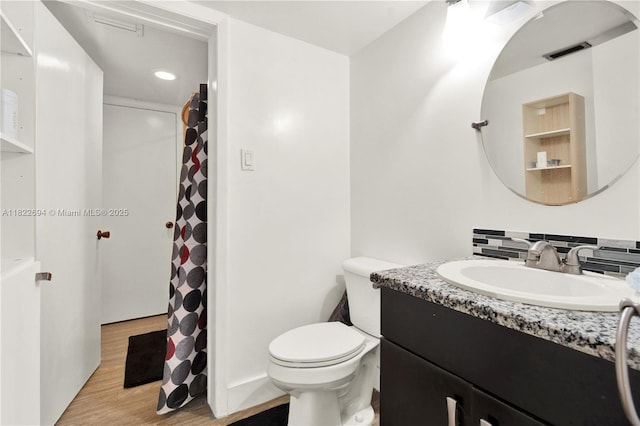 1150 N Liberty Ave Unit 1150G, Homestead, FL 33034 - full bathroom featuring vanity, wood finished floors, decorative backsplash, and a shower with shower curtain