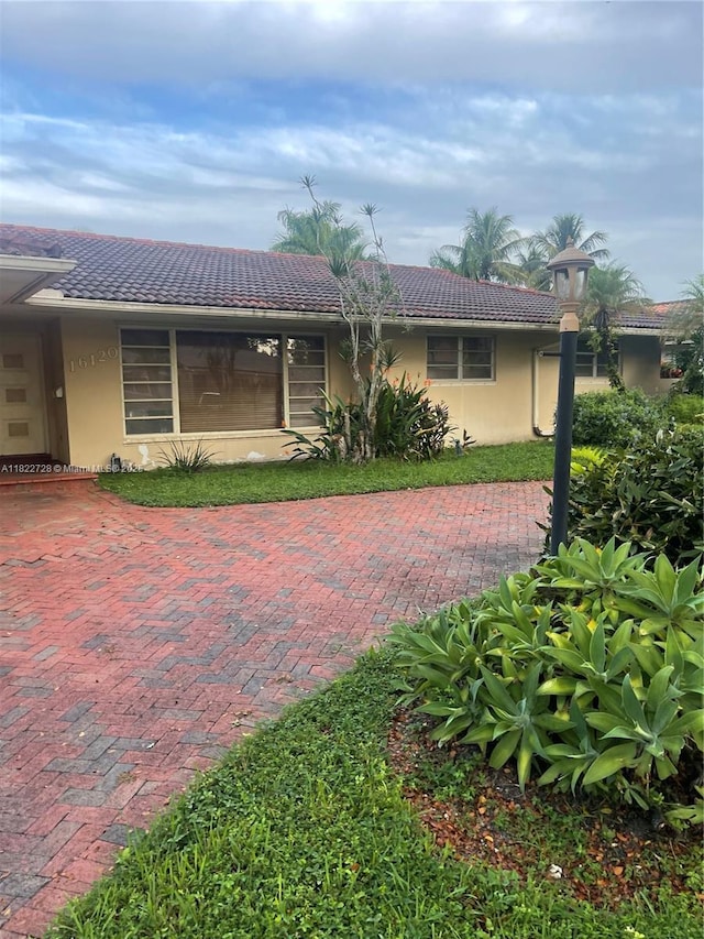16120 E Troon Cir, Miami Lakes, FL 33014 - view of front of home featuring stucco siding and a tile roof