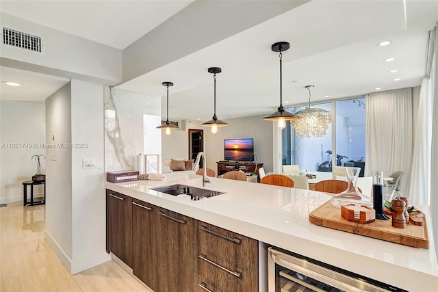 16425 Collins Ave Unit 311, Sunny Isles Beach, FL 33160 - kitchen featuring wine cooler, light countertops, modern cabinets, pendant lighting, and recessed lighting