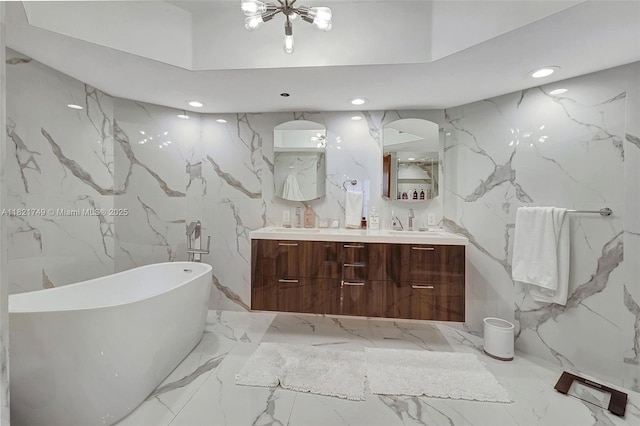 16425 Collins Ave Unit 311, Sunny Isles Beach, FL 33160 - full bathroom with stone wall, a freestanding tub, marble tiled floors, double vanity, and recessed lighting