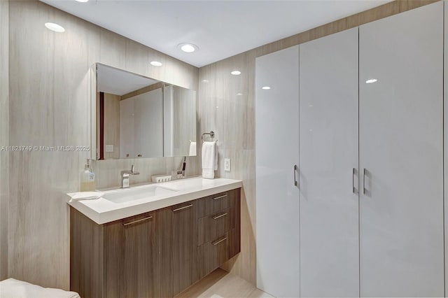 16425 Collins Ave Unit 311, Sunny Isles Beach, FL 33160 - bathroom featuring double vanity, tile walls, and decorative backsplash