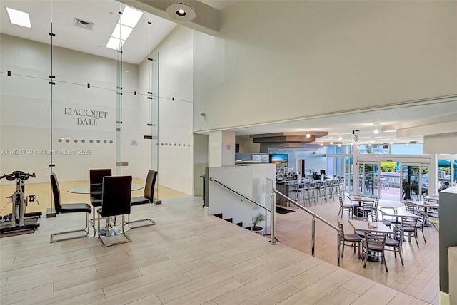 16425 Collins Ave Unit 311, Sunny Isles Beach, FL 33160 - gym with a high ceiling, light wood-type flooring, and a skylight