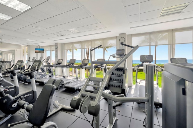 16425 Collins Ave Unit 311, Sunny Isles Beach, FL 33160 - exercise room featuring a paneled ceiling, plenty of natural light, and a water view
