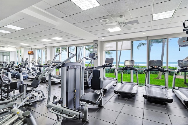 16425 Collins Ave Unit 311, Sunny Isles Beach, FL 33160 - exercise room featuring plenty of natural light, a paneled ceiling, ceiling fan, expansive windows, and a water view