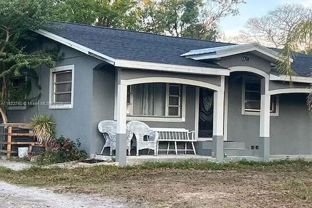 1760 N Clara Ave, Deland, FL 32720 - view of front of property with a porch, roof with shingles, and stucco siding