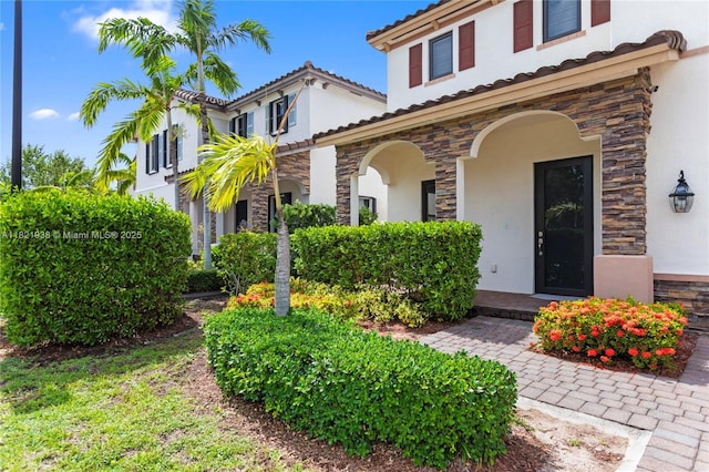 3557 W 94th Ter, Hialeah, FL 33018 - view of front of home featuring stone siding, stucco siding, and a tile roof