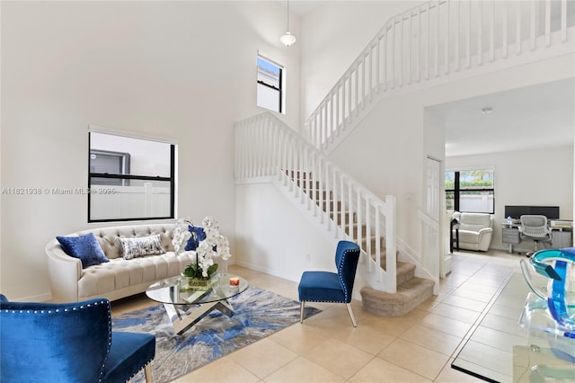 3557 W 94th Ter, Hialeah, FL 33018 - tiled living area featuring stairway, a high ceiling, and a desk