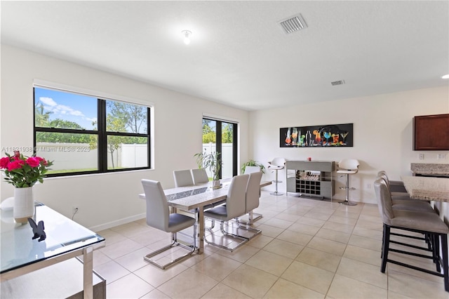 3557 W 94th Ter, Hialeah, FL 33018 - dining area with light tile patterned floors and baseboards