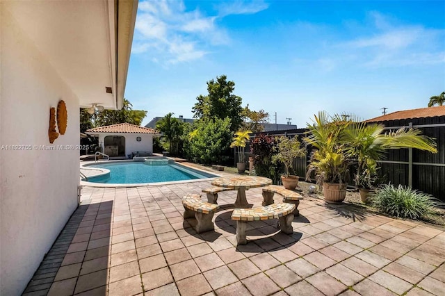 7080 SW 98th Ave, Miami, FL 33173 - view of pool featuring a patio area, a fenced backyard, and a pool with connected hot tub