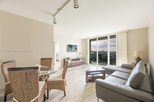 347 N New River Dr E Unit 1505, Fort Lauderdale, FL 33301 - living area with floor to ceiling windows, light wood-style flooring, and rail lighting