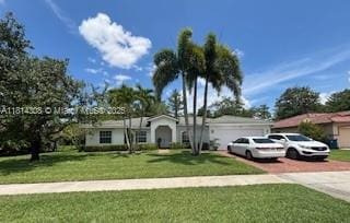 126 Chestnut Cir, Royal Palm Beach, FL 33411 - single story home with a garage, driveway, and a front yard
