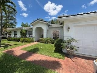 126 Chestnut Cir, Royal Palm Beach, FL 33411 - ranch-style house featuring a garage, a front yard, and stucco siding