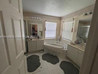 126 Chestnut Cir, Royal Palm Beach, FL 33411 - full bath featuring a bath, two vanities, and a shower stall