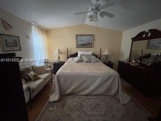 126 Chestnut Cir, Royal Palm Beach, FL 33411 - bedroom with ceiling fan and vaulted ceiling