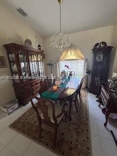 126 Chestnut Cir, Royal Palm Beach, FL 33411 - dining space with healthy amount of natural light, lofted ceiling, a chandelier, and light tile patterned floors