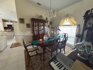 126 Chestnut Cir, Royal Palm Beach, FL 33411 - dining area featuring a chandelier