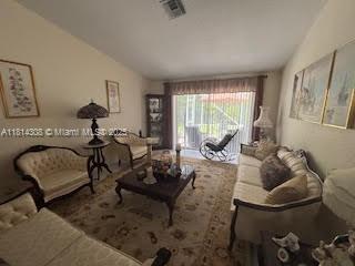126 Chestnut Cir, Royal Palm Beach, FL 33411 - living room featuring lofted ceiling