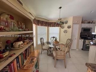 126 Chestnut Cir, Royal Palm Beach, FL 33411 - dining room with light tile patterned floors