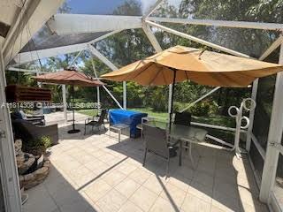 126 Chestnut Cir, Royal Palm Beach, FL 33411 - view of patio / terrace with glass enclosure