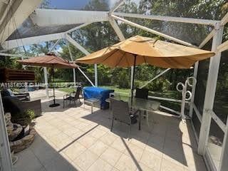 126 Chestnut Cir, Royal Palm Beach, FL 33411 - view of patio with glass enclosure and area for grilling